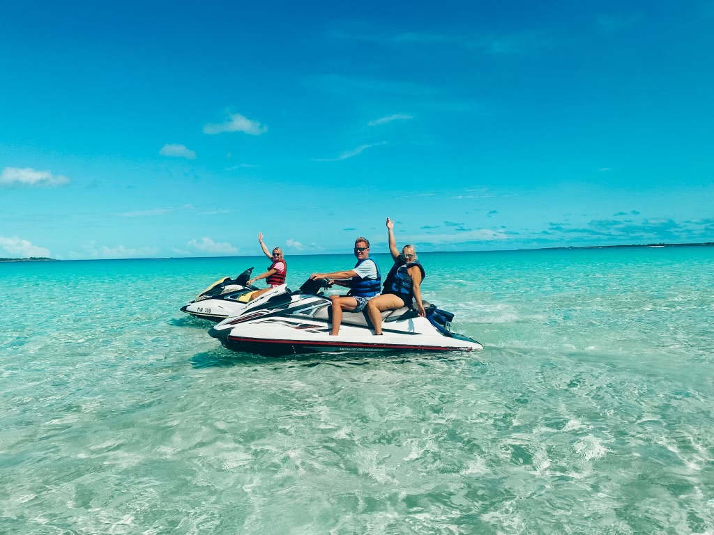 jet ski a man riding on the back of a boat in the ocean